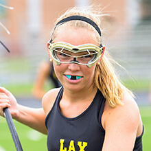 Girl wearing sportsguard to play lacrosse