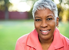 Healthy woman with dental implants in Westfield smiling outside