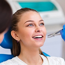 Woman smiling, about to undergo a tooth extraction in Westfield, NJ