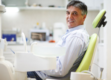 Man sitting in dental chair smiling