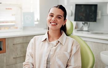 Woman sitting in dental chair smiling