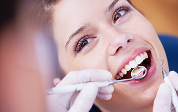 Woman's smile examined by dentist