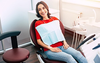 Woman smiling in dental chair after root canal therapy in Westfield, NJ