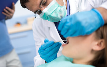Dentist treating relaxed patient