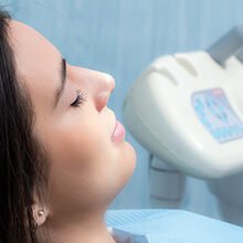 Relaxed patient in dental chair with eyes closed