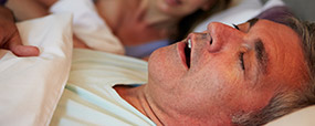 Snoring man in bed