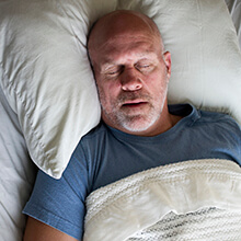 Man sound asleep in bed