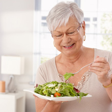 Older woman eating a salad