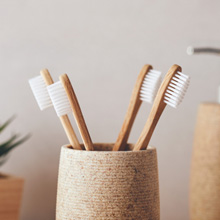 Four toothbrushes sitting in a cup