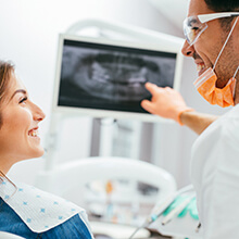 Dentist and patient looking at x-rays