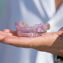 Hand holding TMJ oral appliance