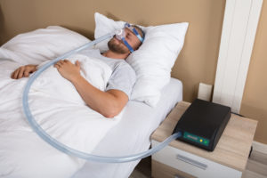 Man with sleep apnea mask