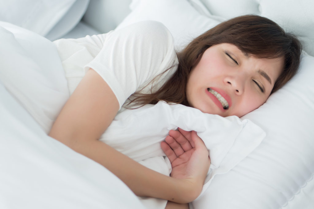 Woman grinding her teeth while sleeping