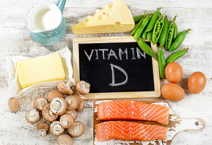 Chalkboard saying “Vitamin D” surrounded by vitamin D-rich foods